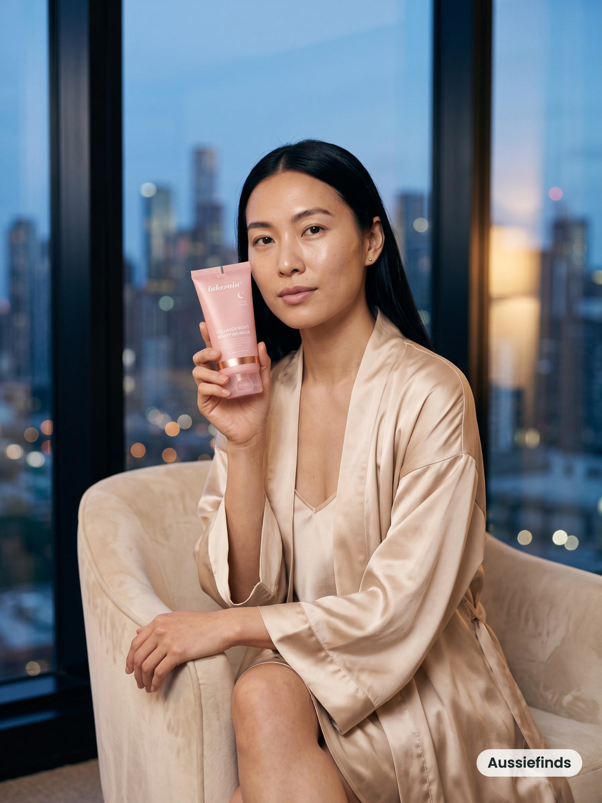 Model holding the Overnight Collagen Mask in a Melbourne hotel suite